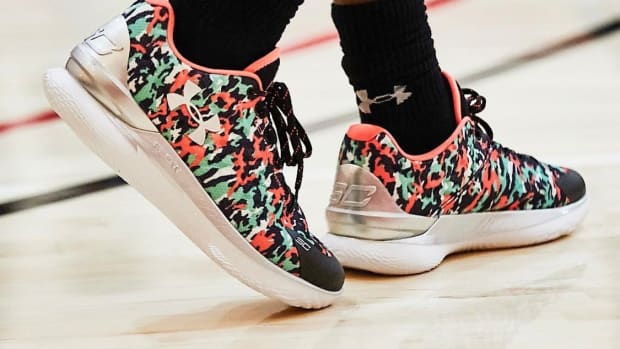 View of black, green, and red Curry One Low shoes.